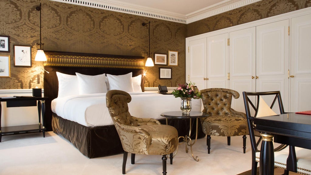 Elegant Premier Room at La Réserve Paris Hotel & Spa, featuring plush cream furnishings, rich wood accents, and soft ambient lighting creating a luxurious Parisian sanctuary