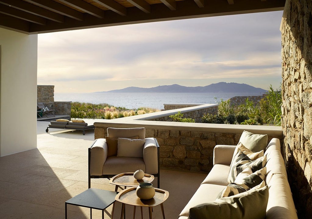 Luxurious one-bedroom suite in Mykonos with panoramic Aegean Sea view, private heated pool, and elegant contemporary Mediterranean design