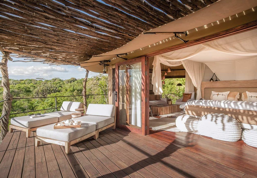 Elegant safari lodge perched on rocky outcrop overlooking African savanna, featuring infinity pool and contemporary stone architecture