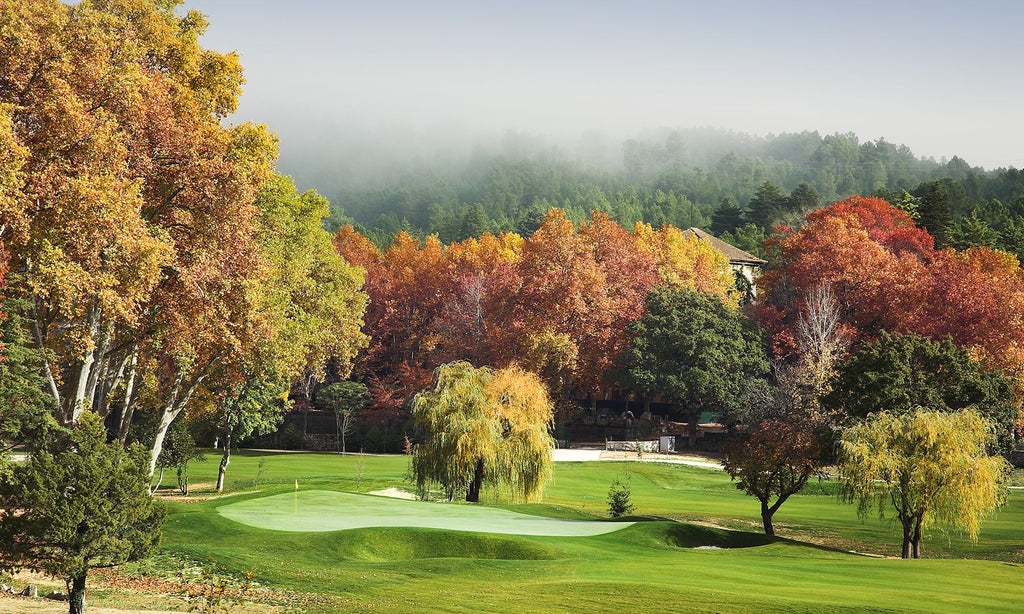 Elegant Art Nouveau palace hotel nestled in lush Portuguese landscape, featuring grand white exterior, manicured gardens, and classic architectural splendor