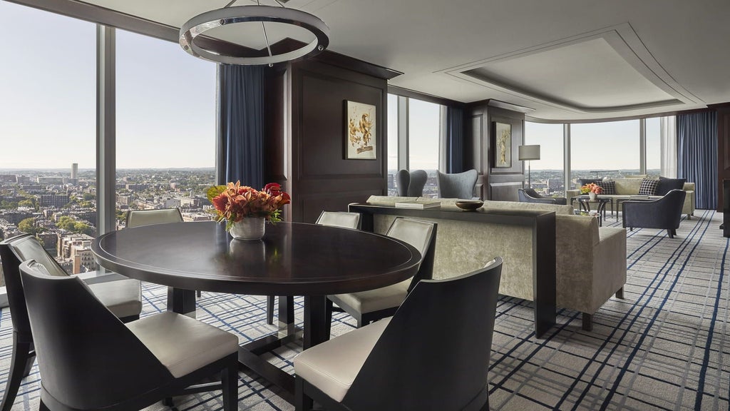 Expansive presidential suite with panoramic city views, elegant contemporary design, plush king bed, marble bathroom, and floor-to-ceiling windows at scenset hotel