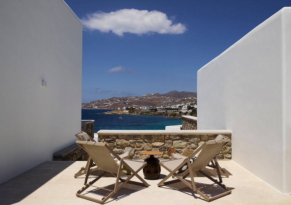 Luxurious three-bedroom villa in Mykonos with panoramic Aegean Sea views, private heated pool, and modern Mediterranean architecture.