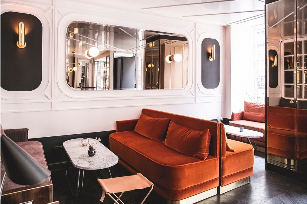 Elegant Art Deco hotel facade in Paris, with chic black and gold signage, classic French architectural details, and warm inviting street-level entrance