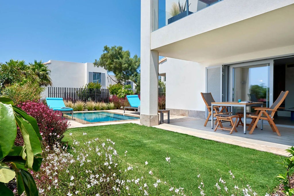 Spacious two-bedroom Garden Pool Suite at 7Pines Resort in Ibiza, featuring modern design, white interiors, and stunning Mediterranean panoramic views.