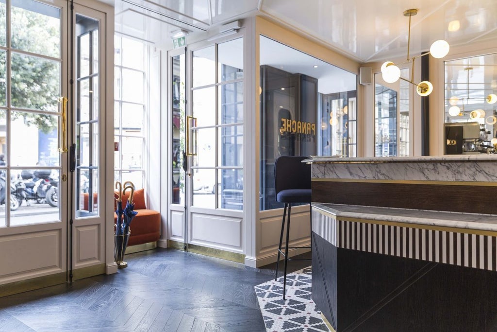 Elegant Parisian boutique hotel with art deco facade, warm terracotta tones, and classic French architectural details against soft urban backdrop