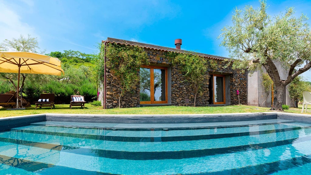 Luxurious two-bedroom pool villa at Monaci delle Terre Nere, nestled in Sicilian countryside with elegant minimalist design and panoramic landscape views