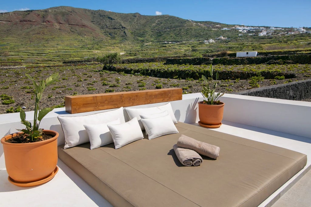 Luxury whitewashed Greek villa with blue shutters nestled on Santorini's cliffside, overlooking azure Aegean Sea with traditional Cycladic architectural charm