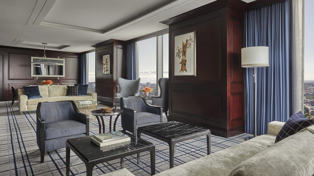 Spacious presidential suite with panoramic city views, elegant king bed, marble bathroom, modern furnishings, and floor-to-ceiling windows at Four Seasons Hotel in Boston