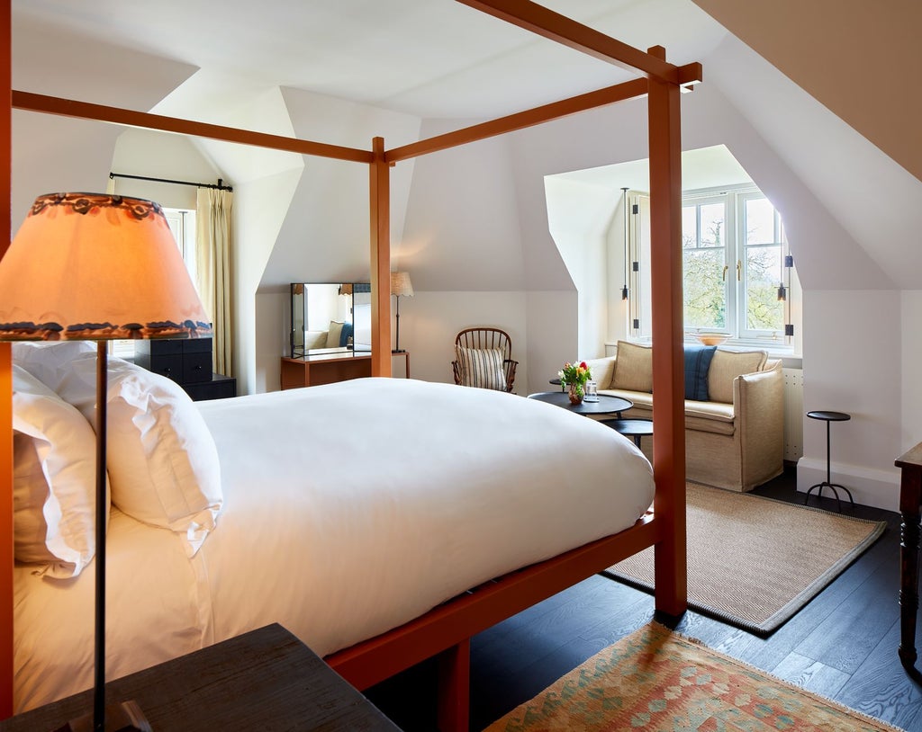 Elegant countryside suite with plush cream armchairs, soft natural lighting, and refined wood furnishings at Grove of Narberth luxury hotel in rural Wales