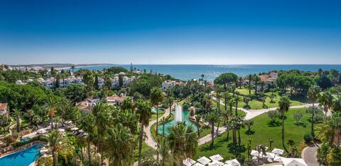 Elegant Mediterranean resort Villa Vita Parc featuring white architecture, oceanfront infinity pools and manicured gardens at sunset