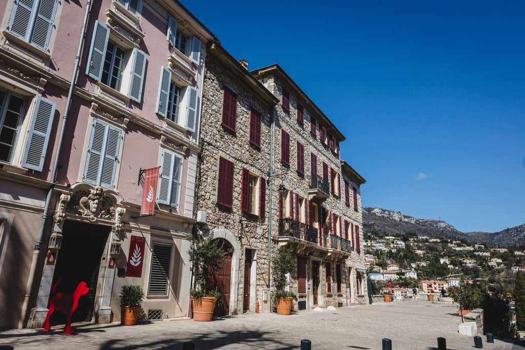 Elegant stone boutique hotel with climbing ivy, nestled in French countryside, showcasing rustic charm and sophisticated architectural details of 