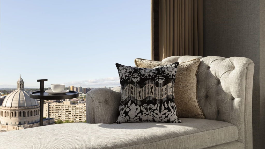 Luxurious deluxe hotel room at Four Seasons One Dalton Street in Boston, featuring panoramic city skyline view and modern elegant interior design