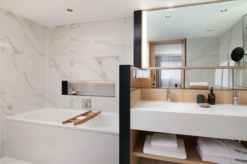 Spacious One Bedroom Suite at Nobu Hotel London Portman Square with contemporary design, plush king bed, and city-view windows overlooking central UK location.