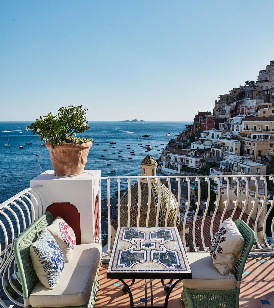 Elegant cliffside hotel in Positano with infinity pool overlooking the Amalfi Coast, Mediterranean Sea and pastel-colored villas