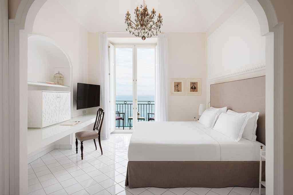 Elegant Suite Lord Astor at Bellevue Syrene, overlooking Sorrento's coastline with opulent maritime-inspired decor, antique furnishings, and panoramic Mediterranean views