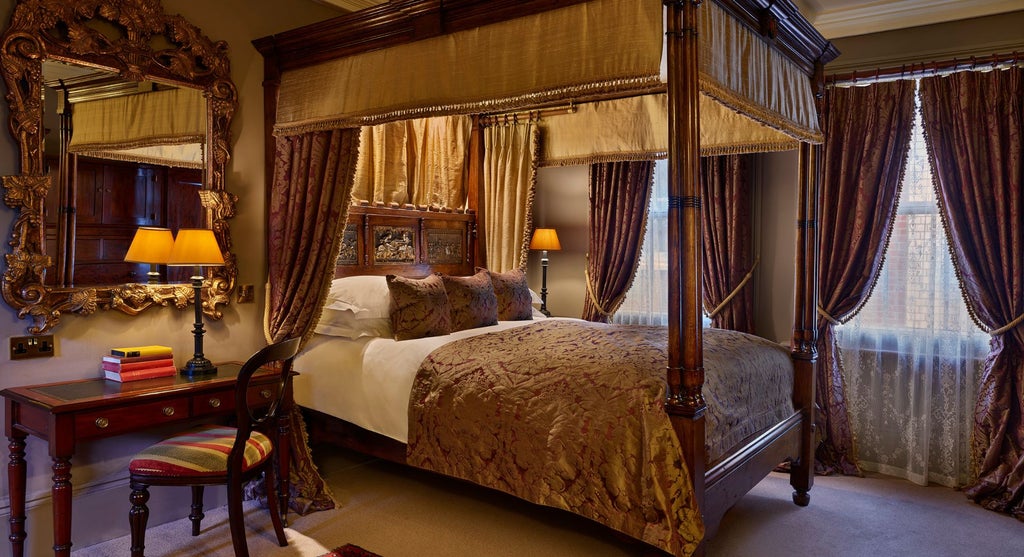 Elegant four-poster bed with rich wooden headboard and luxurious white linens in a refined, traditional United Kingdom hotel room interior