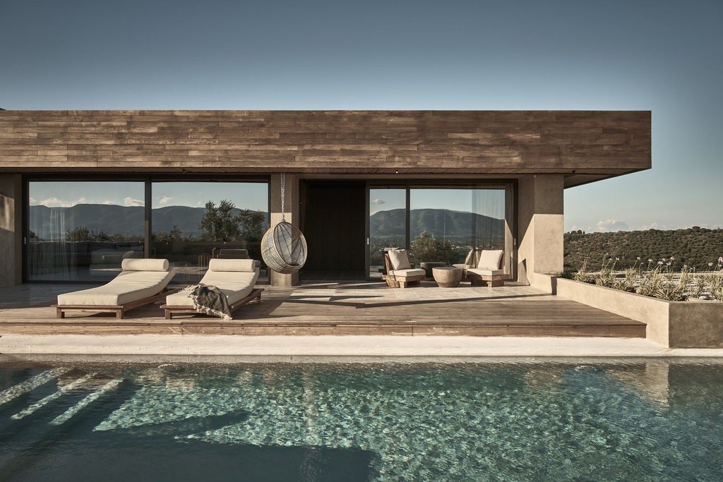 Modern minimalist luxury hotel suite with private infinity pool overlooking Mediterranean Sea, white architecture and natural textures