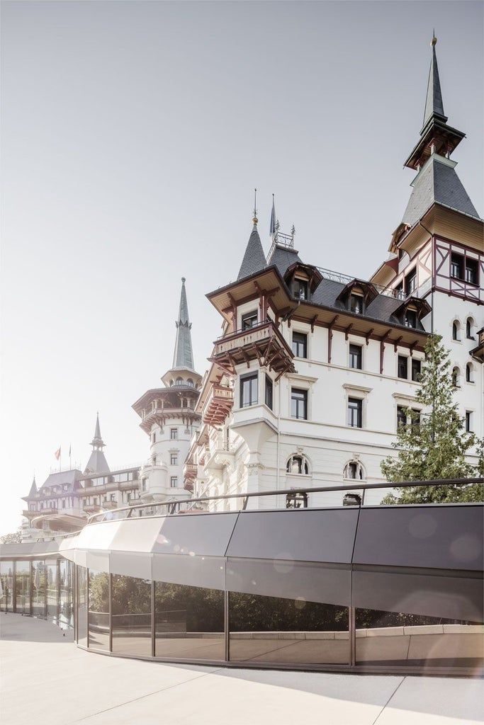 Five-star Dolder Grand Hotel nestled on Zurich hillside, featuring ornate Belle Époque architecture with modern wing and manicured gardens