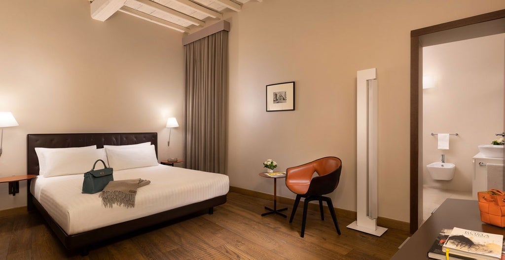 Elegant marble floor, ornate chandelier, and plush king-sized bed in a luxurious hotel room at Palazzo Scanderbeg Annex, Rome, with expansive windows and classic Italian decor