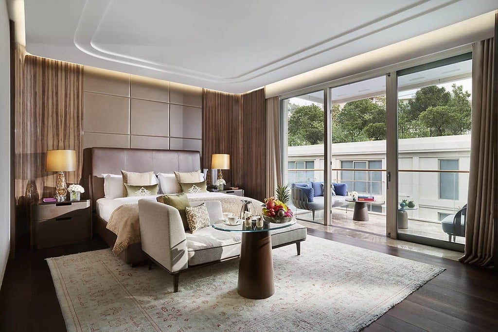 Luxurious junior suite with panoramic Bosphorus views, king bed, modern Turkish design, elegant neutral tones, floor-to-ceiling windows overlooking Istanbul skyline