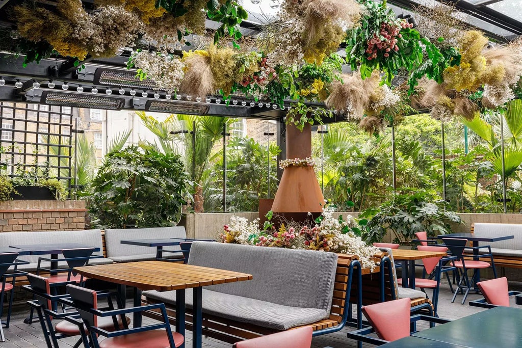 Luxurious rooftop terrace of The Standard hotel in central London, showcasing modern design with sleek furniture and panoramic city skyline views