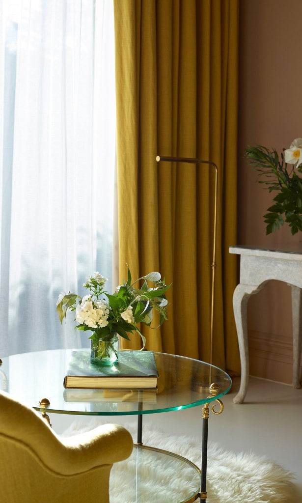 Elegant garden-inspired hotel bedroom with soft green thyme color palette, plush bedding, and natural light streaming through large windows in a UK luxury accommodation