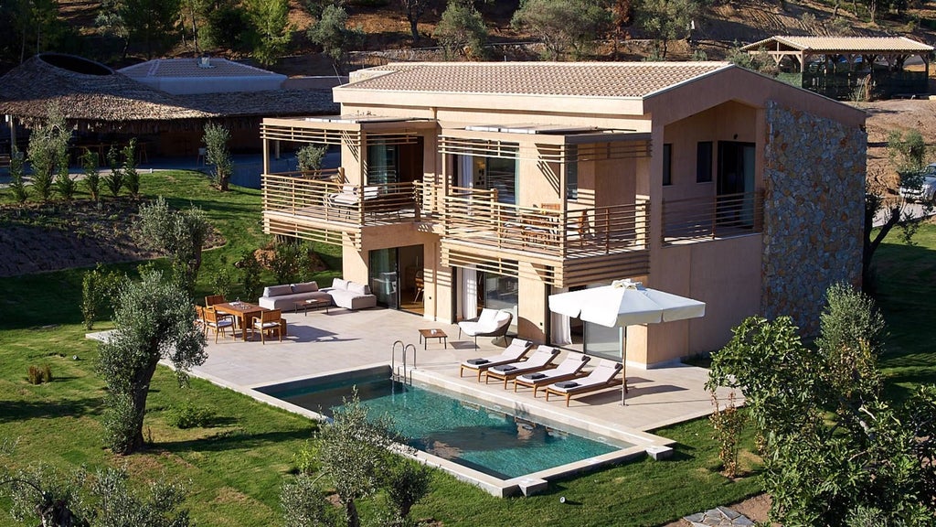 Luxurious SWAN Villa bedroom with panoramic sea view, elegant white decor, plush king bed, and seamless indoor-outdoor design at ELIVI Skiathos resort in Greece