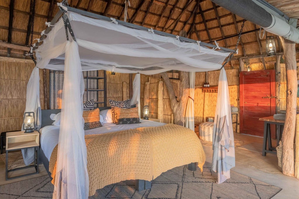Luxurious safari lodge nestled in Zambian wilderness, with canvas tents, wooden decks overlooking river, and warm golden light at dusk