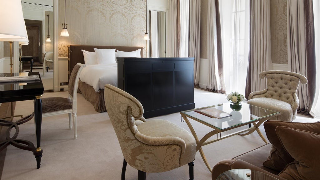 Elegant Parisian luxury suite with plush king bed, silk curtains, marble bathroom, soft neutral tones, and refined contemporary designer furnishings