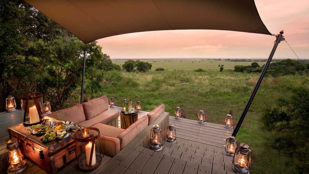 Intimate safari tent suite at Bateleur Camp with canvas walls, antique furnishings, and sweeping views of the Masai Mara plains