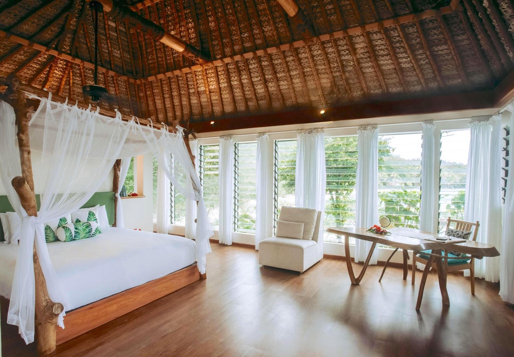 Luxurious beachfront villa with panoramic ocean views, wooden deck, and tropical design featuring native Fijian architectural elements and lush island scenery