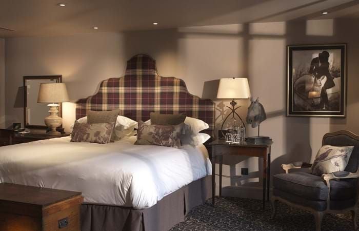 Elegant courtyard classic room at The Lygon Arms, featuring refined decor, plush bedding, and traditional British hospitality with soft natural lighting.