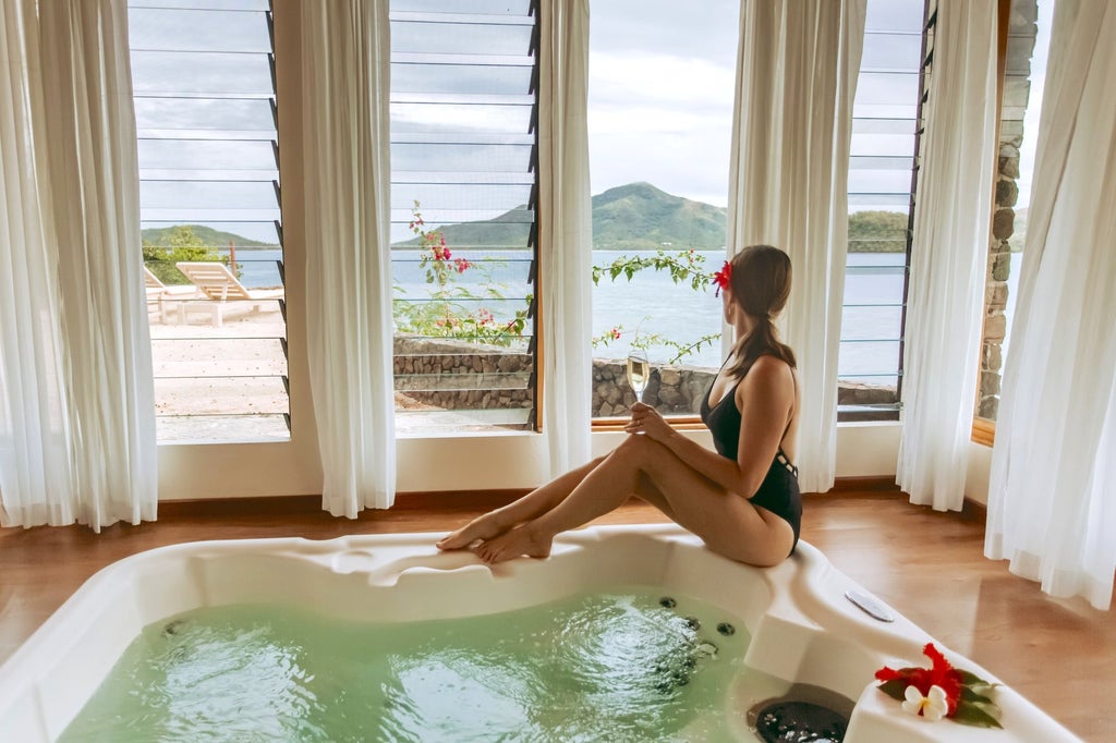 Luxurious Vonu Point Villa with panoramic ocean views, wooden deck, and traditional Fijian design overlooking pristine turquoise waters at Turtle Island resort