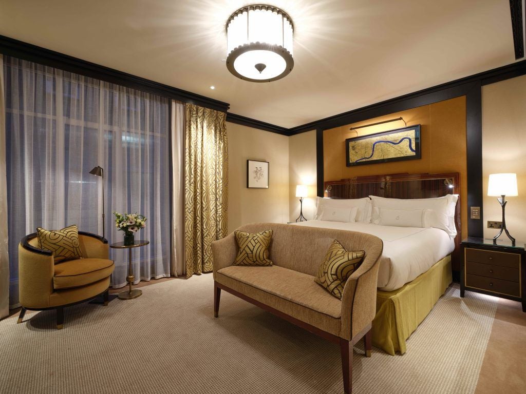 Elegant superior room at upscale Mayfair hotel with plush king bed, soft neutral tones, designer furnishings, and refined contemporary luxury decor