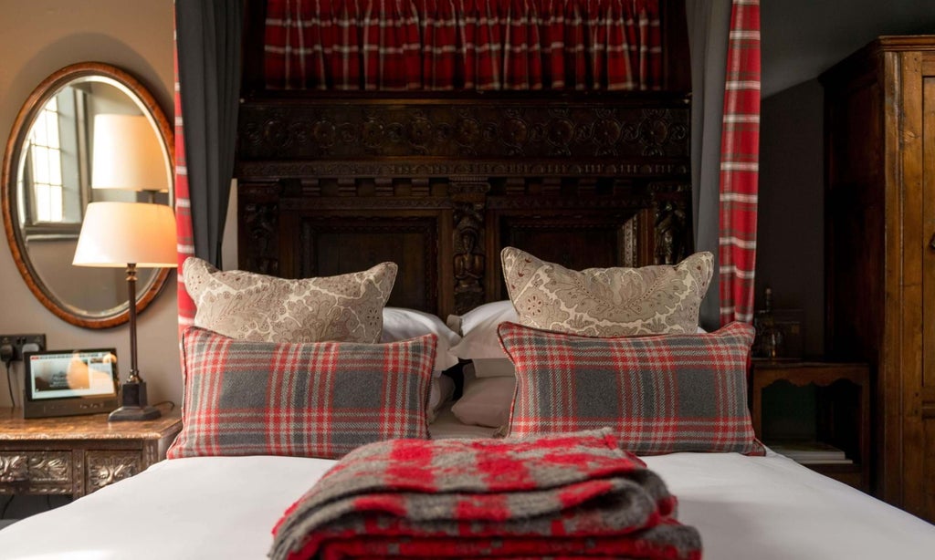 Elegant single room at historic Lygon Arms hotel, featuring classic British decor, soft neutral tones, and luxurious traditional furnishings in Cotswolds setting