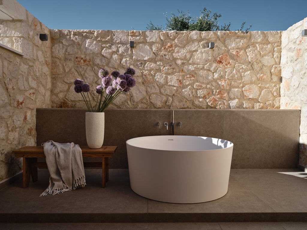 Luxurious white-washed Greek villa bedroom with blue accents, panoramic sea view, minimalist design, and elegant traditional Cycladic architecture