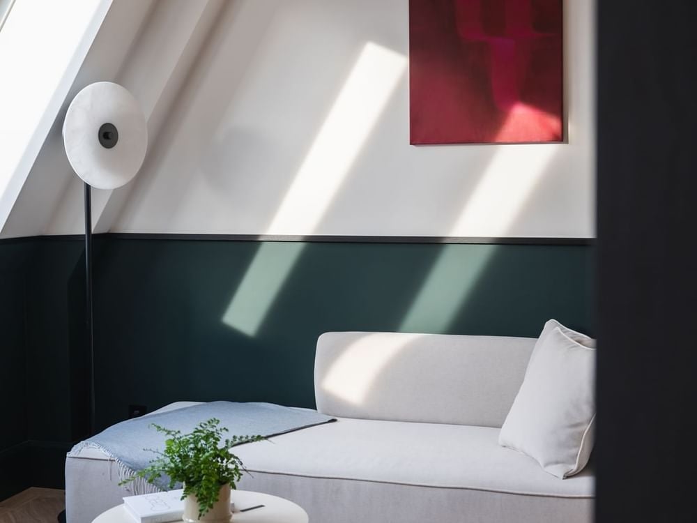 Luxurious hotel suite interior with panoramic Prague Castle view, elegant contemporary design, plush king bed, and sophisticated Czech architectural backdrop