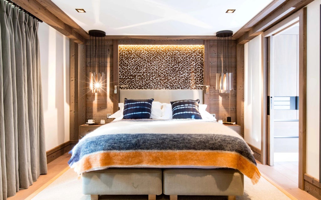 Luxurious alpine three-bedroom family apartment with modern design, elegant furnishings, and panoramic mountain views at Six Senses Residences Courchevel