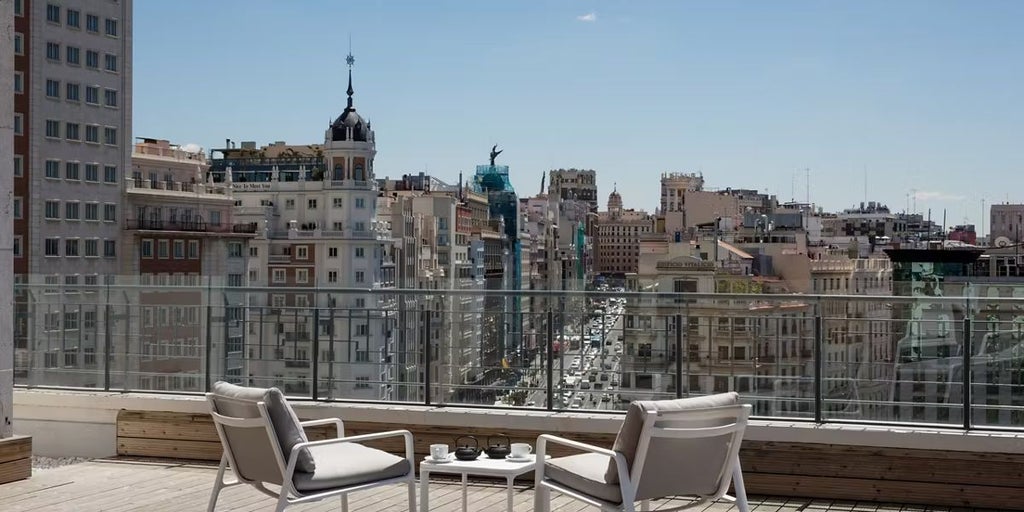 Lavish Royal Suite at Barceló Torre de Madrid, featuring panoramic city views, elegant contemporary decor, plush king bed, and sophisticated marble bathroom