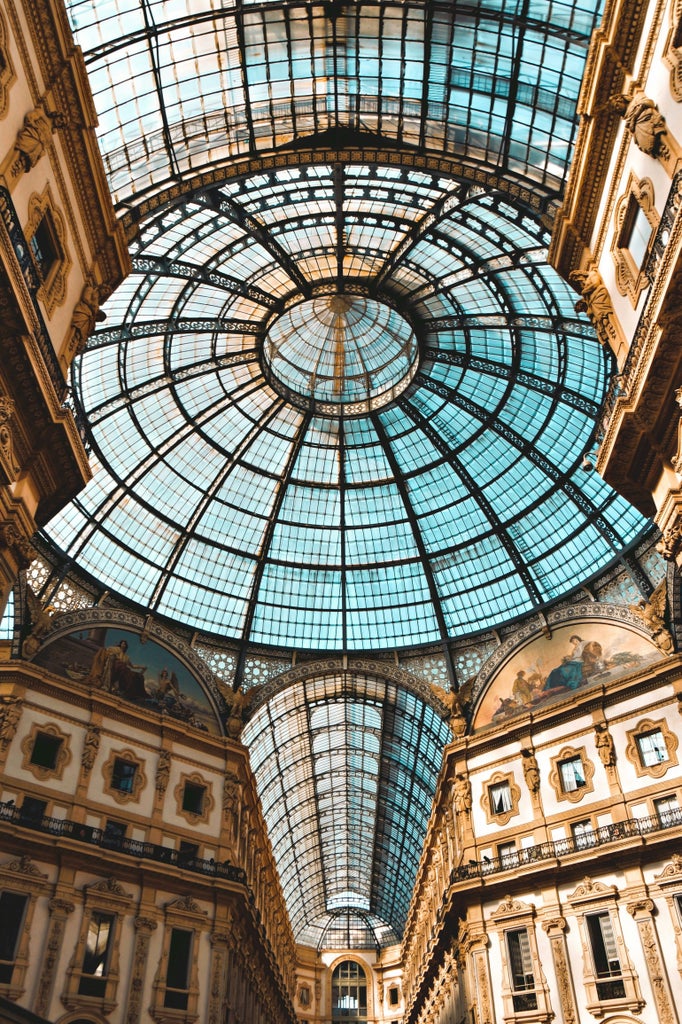 Elegant fashion showroom in Milan featuring high-end garments, luxurious fabrics, and mannequins displaying couture designs