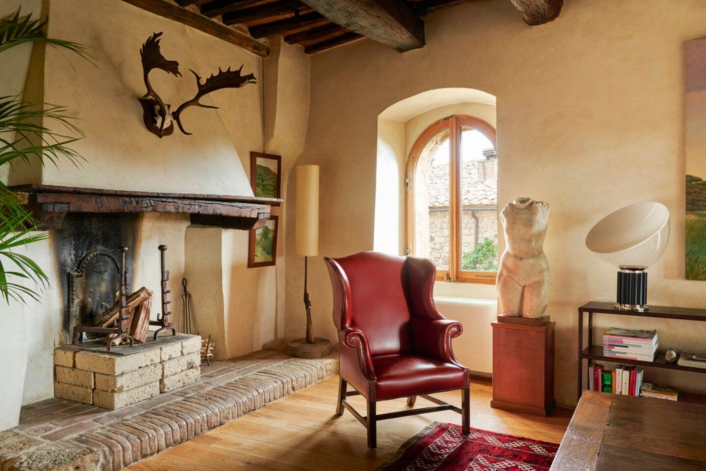 Elegant Italian luxury suite with rustic stone walls, antique wooden furnishings, plush white bedding, and panoramic Tuscan countryside view