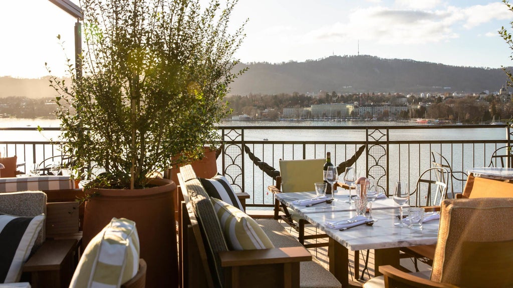 Elegant lakeside luxury hotel nestled in Zurich, with pristine blue waters, alpine mountains, and sophisticated Swiss architectural design