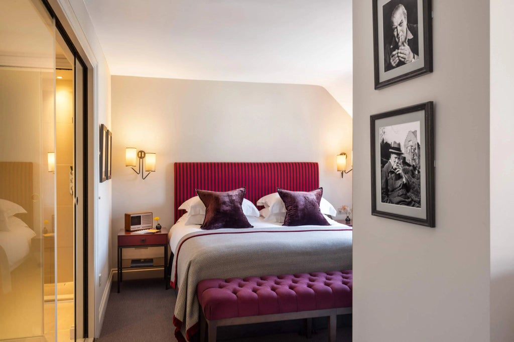 Elegant historic hotel room with expansive windows overlooking UK cityscape, featuring vintage furnishings and sophisticated architectural details from early 20th century