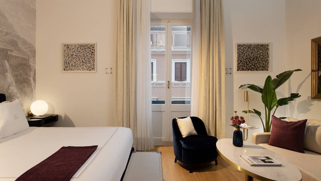 Elegant deluxe junior suite with modern Italian design, soft neutral tones, luxurious king bed, and sleek marble bathroom in a boutique Rome hotel room