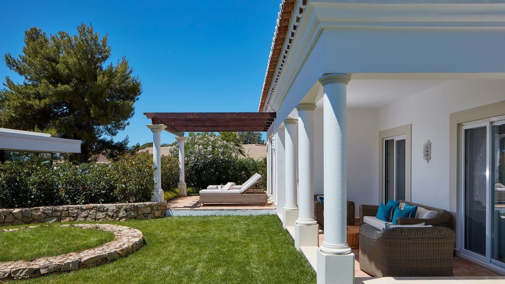 Spacious two-bedroom spa suite at luxury Portuguese resort, featuring elegant furnishings, modern design, and panoramic ocean views with natural light and sophisticated decor