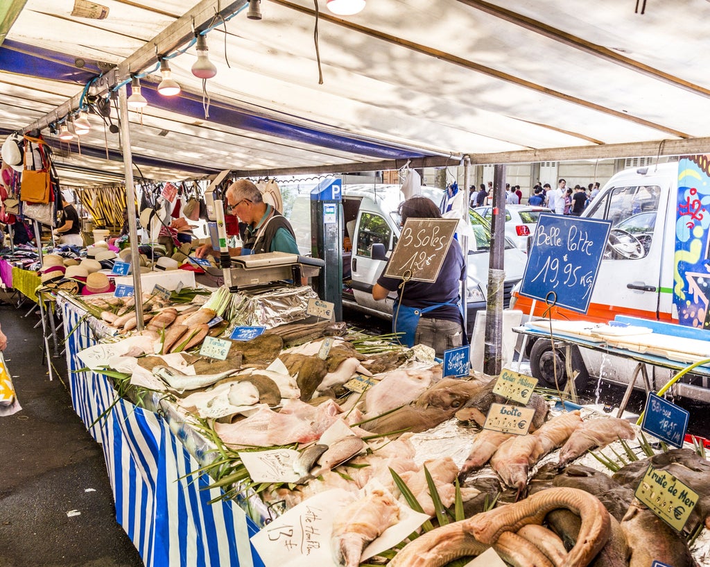 Vibrant French market scene with elegant chef selecting fresh produce, colorful stalls, and traditional cooking ingredients in scenic European setting