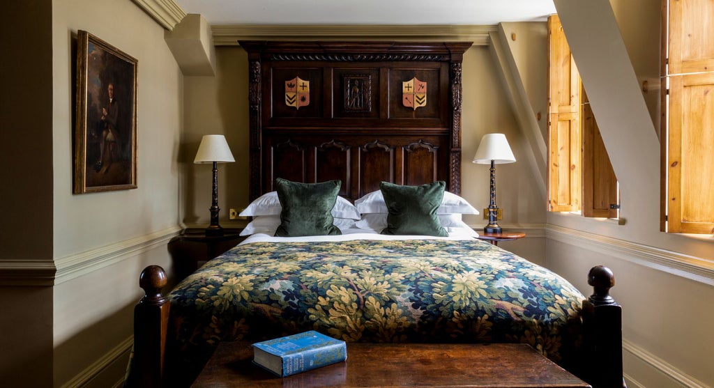 Elegant Georgian-style hotel room with plush bedding, antique furnishings, and soft neutral color palette at Batty Langley's boutique lodging in United Kingdom