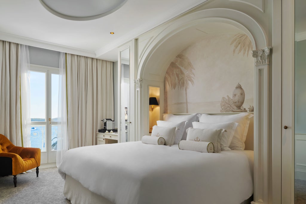 Five-star Hotel Palace Elizabeth's ornate beige facade with elegant balconies and arched windows overlooking Hvar's historic marina and harbor