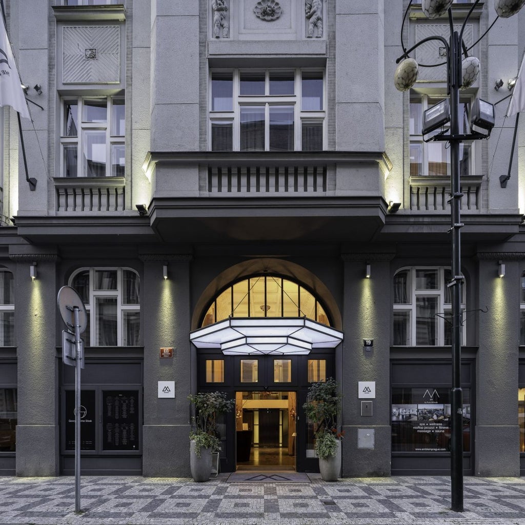 Elegant art deco lobby of luxury boutique hotel in Prague, featuring plush seating, golden accents, and sophisticated design with Czech architectural influences