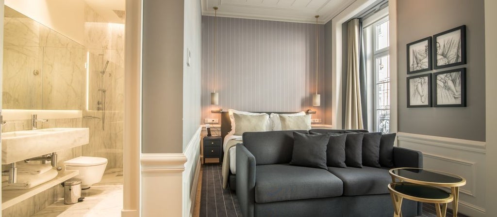 Elegant deluxe hotel room in Porto, featuring modern Portuguese design with panoramic city skyline view, plush white bedding, and minimalist decor